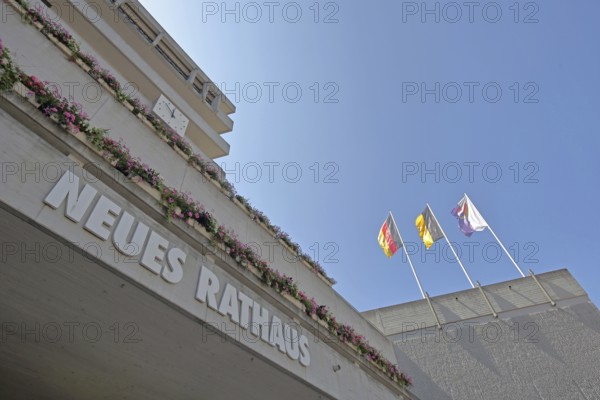 New town hall with three flags, modern building with inscription, national flag, Baden-Württemberg state flag, city flag with city coat of arms, clock, floral decoration, Pforzheim, Northern Black Forest, Black Forest, Baden-Württemberg, Germany