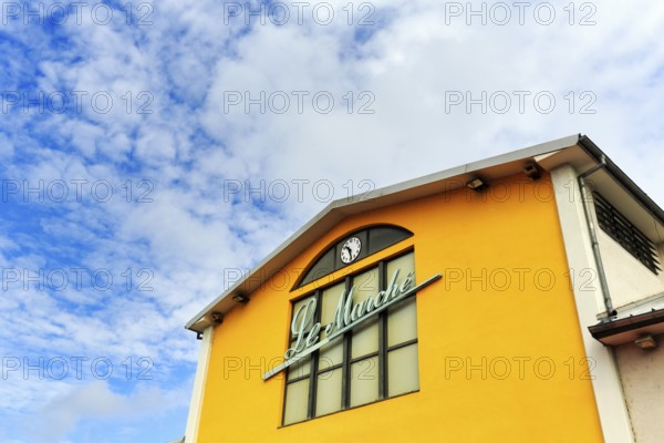 Market hall with inscription Le Marché, yellow facade detail, Mulhouse, Alsace, France