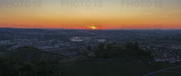 Panoramic view of a city at sunset with vineyards in the foreground and orange sky, Grabkapelle, Zum Württemberg, Rotenberg district, Stuttgart, Baden-Württemberg, Germany