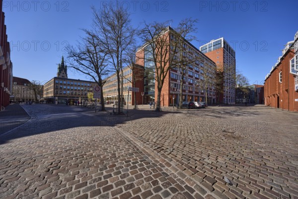 Stadthaus 1, city centre, brick building, bare wintry trees, cobblestone alleyway, blue cloudless sky, intersection between Heinrich-Brüning-Straße, Loerstraße, Stubengasse and Klemensstraße, Münster, Münsterland, independent city, North Rhine-Westphalia, Germany