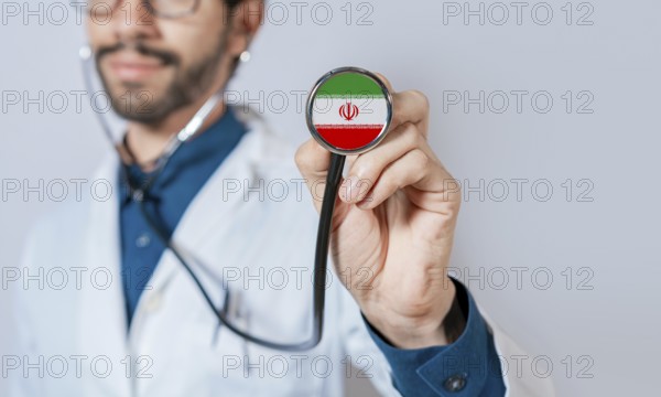 Doctor holding stethoscope with Iran flag. Iran health and care concept, Iran flag on stethoscope