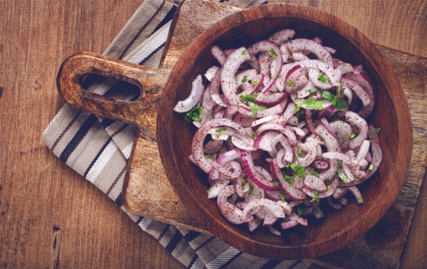 Chopped red onion, with sumac and herbs, in a bowl, pickled Spanish onion, close-up, top view