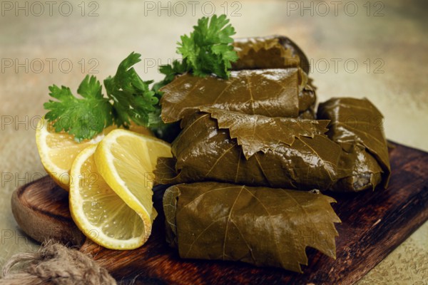 Dolma, minced meat with rice, in grape leaves, minced meat rolls, on a chopping board, top view, no people