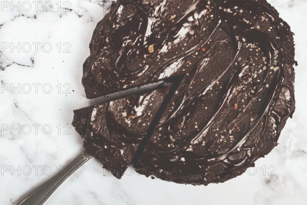 Chocolate cake, round cake, on a marble light table, top view, homemade cakes, no people