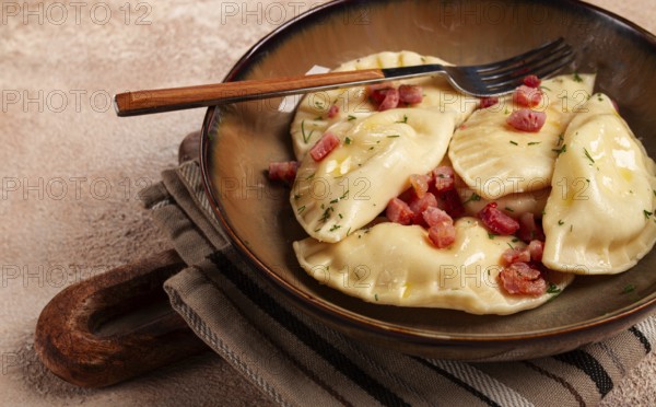 Dumplings, with fried prosciutto, a traditional dish of Polish cuisine, dumplings, top view, close-up, without people