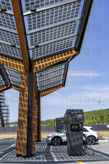 Electric charging station on the site of the former Lohberg colliery in Dinslaken, operated by Fastned, uses electricity from wind power and solar energy, fast-charging columns, with its own solar roof, wind farm on the Lohberg slagheap, North Rhine-Westphalia, Germany