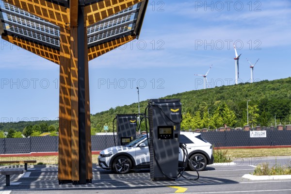 Electric charging station on the site of the former Lohberg colliery in Dinslaken, operated by Fastned, uses electricity from wind power and solar energy, fast-charging columns, with its own solar roof, wind farm on the Lohberg slagheap, North Rhine-Westphalia, Germany
