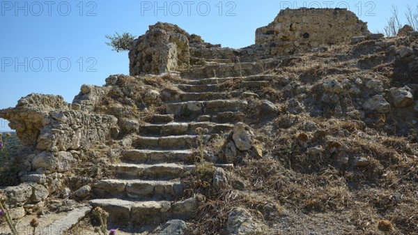 Dilapidated stone steps in an arid landscape dotted with ruins, Antimacheia, Medieval fortress, St John's fortress, Antimachia, Kos, Dodecanese, Greek Islands, Greece