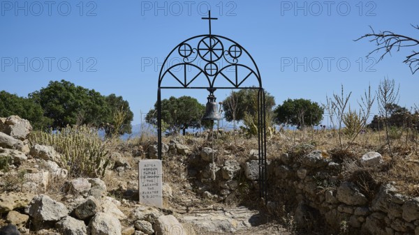 Bell tower with cross in a ruin with trees and clear sky in the background, Church of Agia Paraskevi, Antimacheia, Medieval Fortress, St John's Fortress, Antimachia, Kos, Dodecanese, Greek Islands, Greece