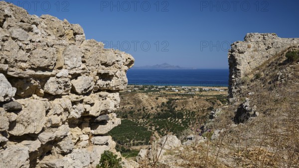 View through ancient ruins to a rocky landscape with the sea in the background, Kardamina, Antimacheia, Medieval fortress, St John's fortress, Antimachia, Kos, Dodecanese, Greek Islands, Greece