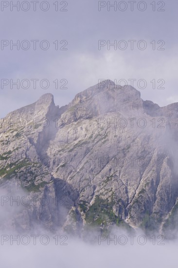 Large rocks rise majestically into the sky in the mist, Dolomites, South Tyrol, Dolomites, Italy
