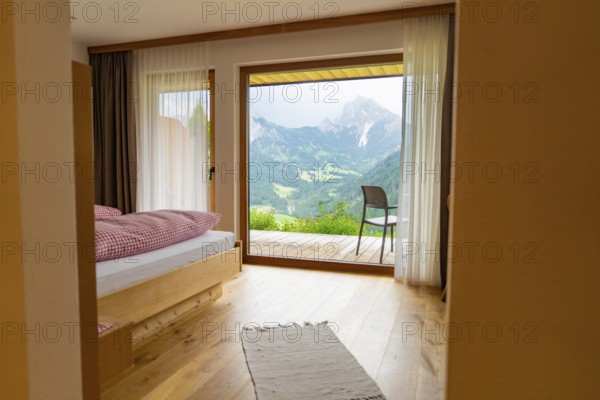 Bright wooden room with large panoramic window and mountain view, Dolomites, South Tyrol, Dolomites, Italy