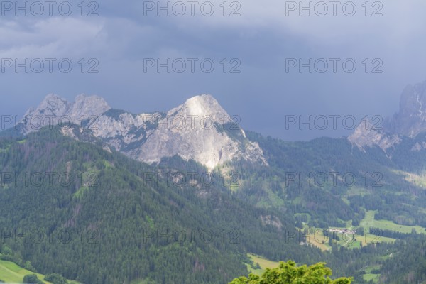 Majestic mountains in a cloudy landscape with green forests, Dolomites, South Tyrol, Dolomites, Italy