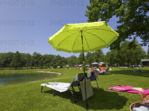 Sunshades and sunbeds by a lake
