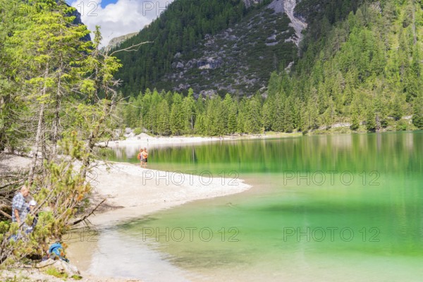 Peaceful landscape with lake and beach, surrounded by forest and mountains, Pragser Wildsee, South Tyrol, Dolomites, Italy