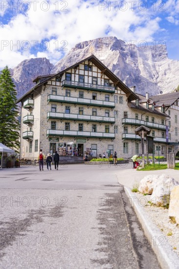 A large hotel in alpine surroundings with mountains and trees in the background, Lake Braies, South Tyrol, Dolomites, Italy