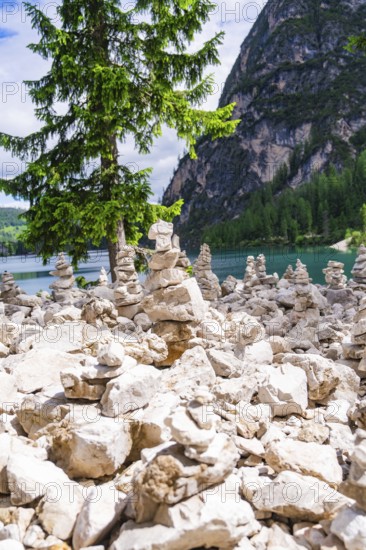 Cairn in front of a mountain lake, relaxing scene in nature, Pragser Wildsee, South Tyrol, Dolomites, Italy
