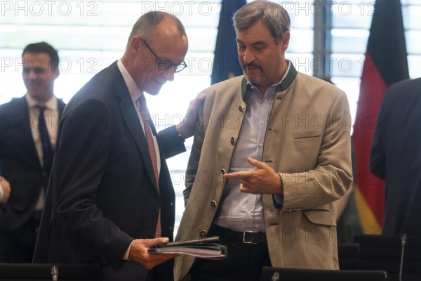 Federal Chancellor Friedrich Merz (l, CDU) and Markus Söder (CSU Chairman and Minister President of Bavaria) in front of the meeting between Federal Chancellor Friedrich Merz and the heads of government of the federal states in the International Conference Hall of the Federal Chancellery, Berlin, 18 June 2025