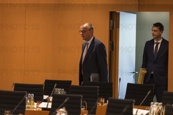 Federal Chancellor Friedrich Merz (l, CDU) arrives for the consultation between Federal Chancellor Friedrich Merz and the heads of government of the federal states in the International Conference Hall of the Federal Chancellery, Berlin, 18 June 2025