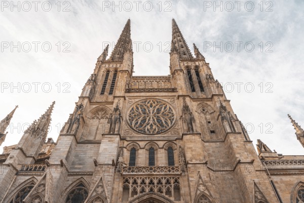 Low angle view of the facade of st. Andrew's cathedral, highlighting its intricate gothic architecture and towering spires against a cloudy sky