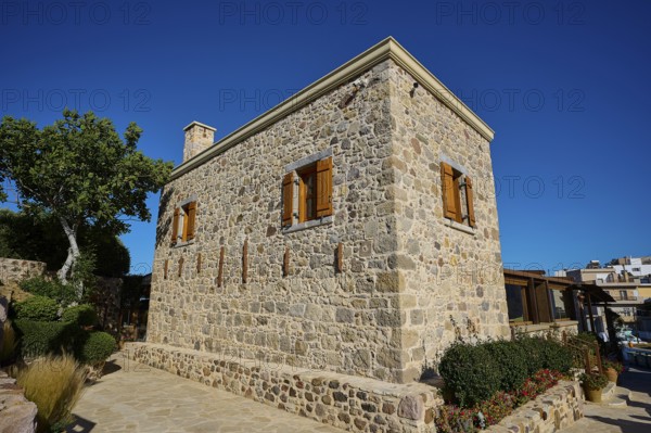Rustic stone house with manicured garden and clear skies, Kefalos, Kos, Dodecanese, Greek Islands, Greece