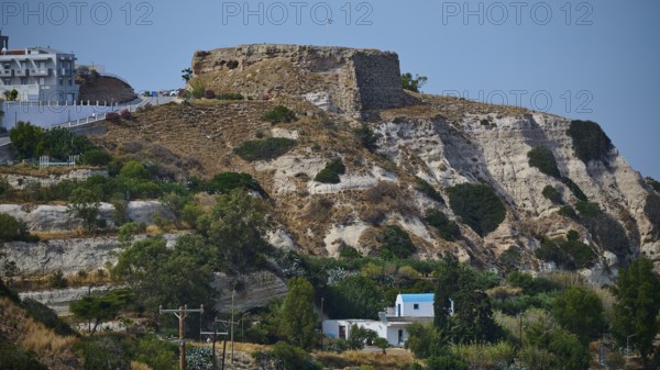 Castle, Historic ruins on an overgrown hill overlooking a rocky landscape under a blue sky, Kefalos, Kos, Dodecanese, Greek Islands, Greece
