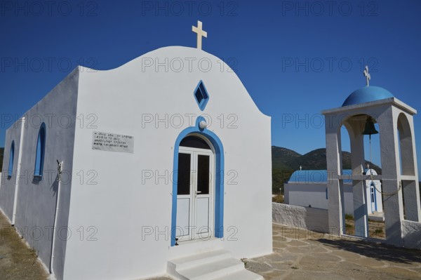 Chapel of Agios Charalambos, White chapel with blue detail and a bell tower under a clear sky, Kefalos, Kos, Dodecanese, Greek Islands, Greece