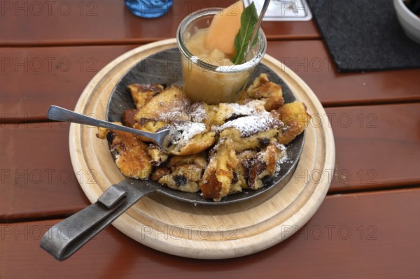 Kaiserschmarrn with apple sauce served in a small pan, Franconia, Bavaria, Germany