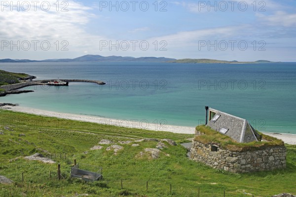 Expansive beach landscape with a lonely stone house and rolling hills in the background, Bonnie Prince Charles, Isle of Barra, Hebrides, Scotland, United Kingdom