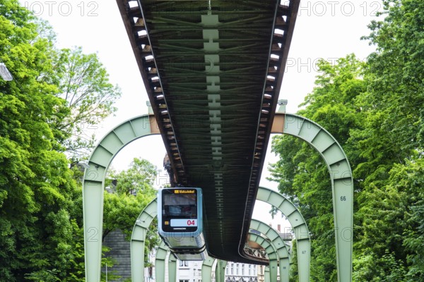 The Wuppertal suspension railway runs through Vohwinkel in front of buildings from the Wilhelminian era near the Hammerstein stop in Wuppertal, Germany