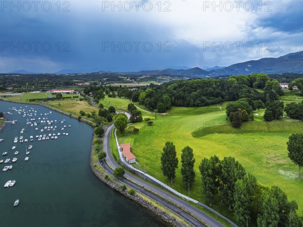 Sunset and storm clouds over Pyrenees and Saint-Jean-de-Luz from a drone, Nouvelle-Aquitaine, Pyrenees-Atlantiques, France