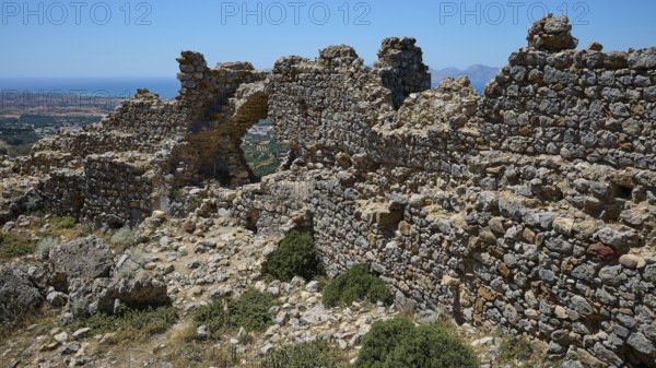 Stone ruins overlook a vast landscape under a clear sky, Abandoned Village, Lost Place, Pyli, Paleo Pyli, Byzantine Fortress, Kos, Dodecanese, Greek Islands, Greece
