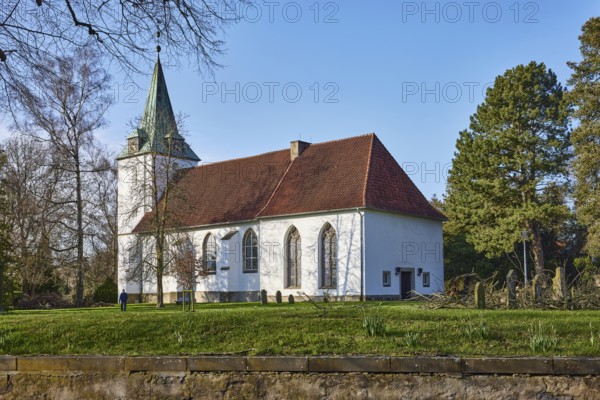Evangelical Lutheran Church Hille, cemetery, sandstone wall, bare winter trees, blue cloudless sky, Eickhorster Straße, Hille, Mühlenkreis Minden-Lübbecke, North Rhine-Westphalia, Germany