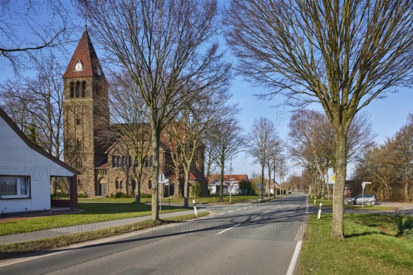 Church Oberlübbe, Evangelical-Lutheran parish Oberlübbe-Rothenuffeln, residential building, bare winter trees, blue sky with cumulus clouds, intersection Ellernstraße with Korfskamp, Hille, Mühlenkreis Minden-Lübbecke, North Rhine-Westphalia, Germany