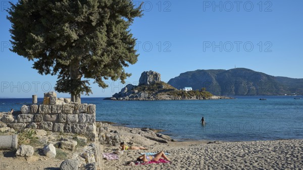 Summer beach view with view of a small island and chapel, Agios Stefanos Beach, Agios Stefanos Basilica, Chapel Agios Nikolaos, Kastri Island, Kos, Dodecanese, Greek Islands, Greece