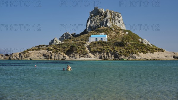Small chapel with blue roof on rocky island in clear sea, Agios Stefanos Beach, Agios Stefanos Basilica, Chapel Agios Nikolaos, Kastri Island, Kos, Dodecanese, Greek Islands, Greece