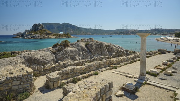 Ruins with a view of an island in the background, bright blue sea, Agios Stefanos Beach, Agios Stefanos Basilica, Agios Nikolaos Chapel, Kastri Island, Kos, Dodecanese, Greek Islands, Greece
