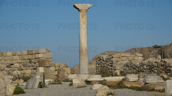 Ruins with a towering ancient column against a clear sky, Agios Stefanos Beach, Agios Stefanos Basilica, Agios Nikolaos Chapel, Kastri Island, Kos, Dodecanese, Greek Islands, Greece