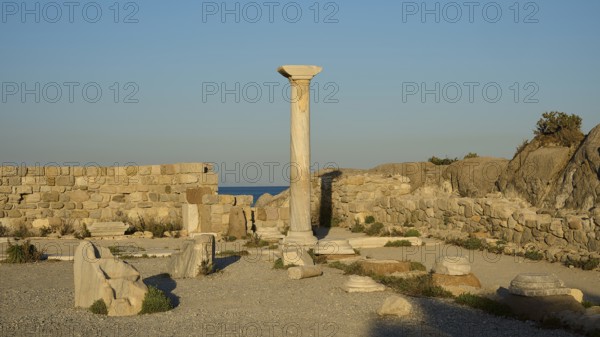 Historic site with a single preserved column surrounded by ancient walls and sea views, Agios Stefanos Beach, Agios Stefanos Basilica, Agios Nikolaos Chapel, Kastri Island, Kos, Dodecanese, Greek Islands, Greece