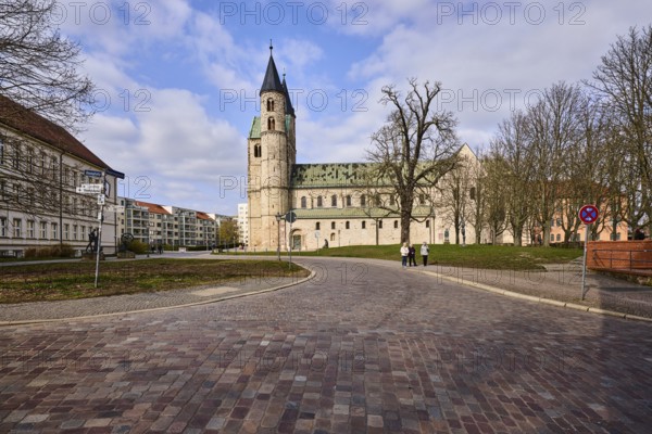 Kloster Unser Lieben Frauen, monastery, church, lawn, bare wintry trees, cobblestone street, blue sky, cumulus clouds, intersection of Gouvernementsberg street with Domplatz and Regierungsstraße, Magdeburg, state capital, independent city, Saxony-Anhalt, Germany