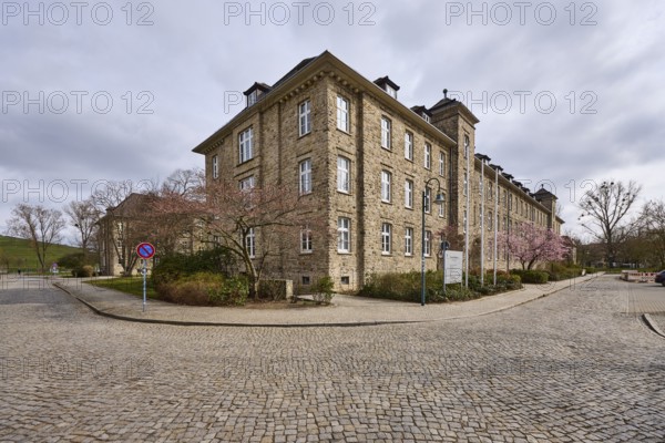 Tax office, sandstone building, bare wintry trees, diffuse light, slightly sunny, cloudy, street Tessenowstraße, Magdeburg, state capital, independent city, Saxony-Anhalt, Germany