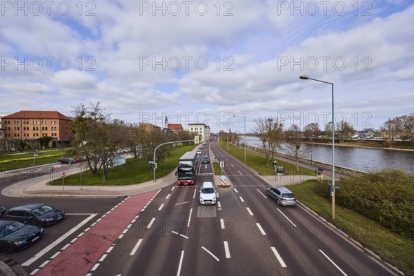 River Elbe, streets, traffic lights, lane markings, lanes, vehicles, cars, coach, bare wintry trees, lanterns, lawn, bird's eye view, diffuse light, blue sky, cumulus clouds, intersection Schleinufer with Gouvernementsberg and Fürstenwallstraße, Magdeburg, state capital, independent city, Saxony-Anhalt, Germany