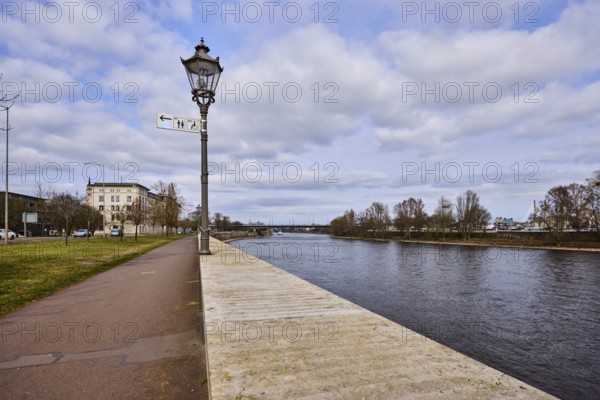 River Elbe, riverside promenade, lantern, sandstone wall, bare wintry trees, general architecture, diffuse light, blue sky, cumulus clouds, banks of the river Schlein, Magdeburg, state capital, independent city, Saxony-Anhalt, Germany