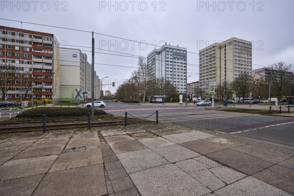 High-rise buildings, residential buildings, residential silos, tram tracks, overhead lines, diffuse light, cloudy, intersection Salvador-Allende-Straße with Barleber Straße, Magdeburg, state capital, independent city, Saxony-Anhalt, Germany