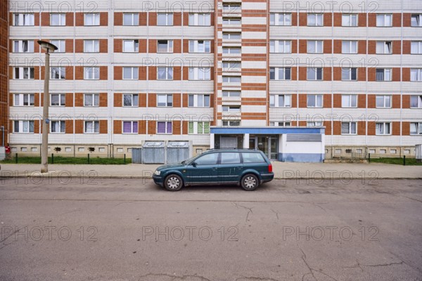 High-rise building, residential building, facade, window, door, parking lane, vehicle, lantern, asphalt, diffuse light, Lumumbastrasse, Magdeburg, state capital, independent city, Saxony-Anhalt, Germany