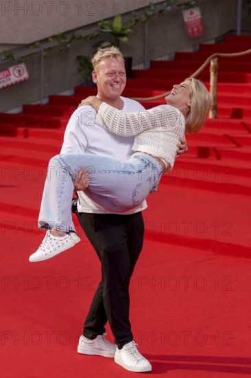 Jens Knossi Knossalla with girlfriend Lia Mitrou (influencer) at the German premiere of the adventure film Jurassic World: Rebirth at Berlin's Zoo Palast on 18 June 2025