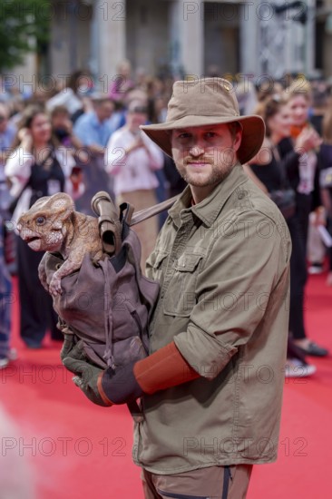 Actors with doll Dolores, which represents an aquilope from the Cretaceous period, at the German premiere of the adventure film Jurassic World, the rebirth at Berlin's Zoo Palast on 18 June 2025
