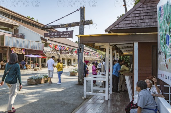 Visitors line up to purchase admission tickets to various parts of the Doi Tung tourist attraction in Chiang Rai, Thailand