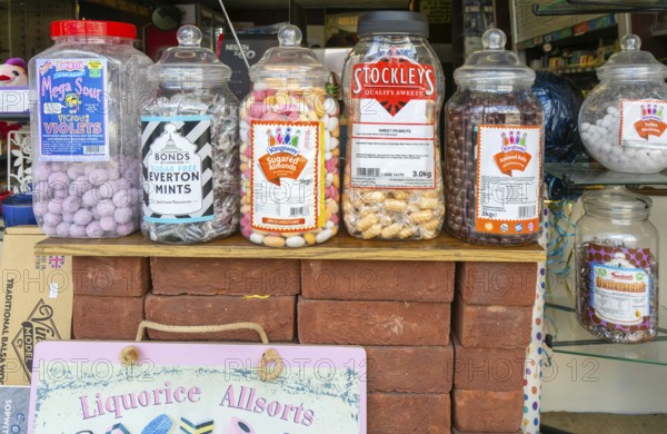 Jars of traditional sweets in shop window, Fisherton Street, Salisbury, Wiltshire, England, UK
