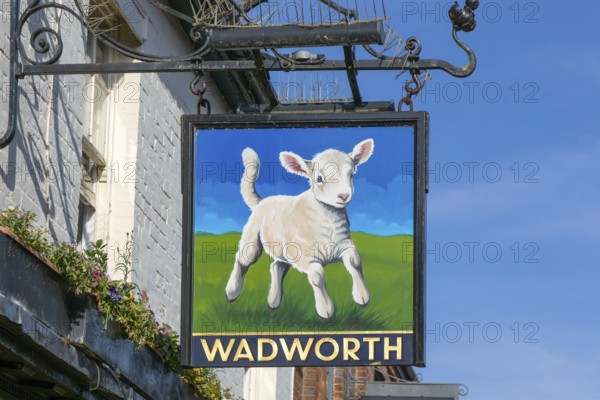 Wadworth brewery traditional pub sign, The Lamb, Marlborough, Wiltshire, England, UK